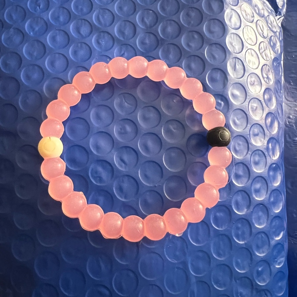 Lakoi Live Waterproof Pink Bracelet with a cream & black bead, good/excellent
